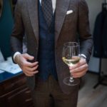 Man with suit and glass of champagne at Dalbiondo's show-room